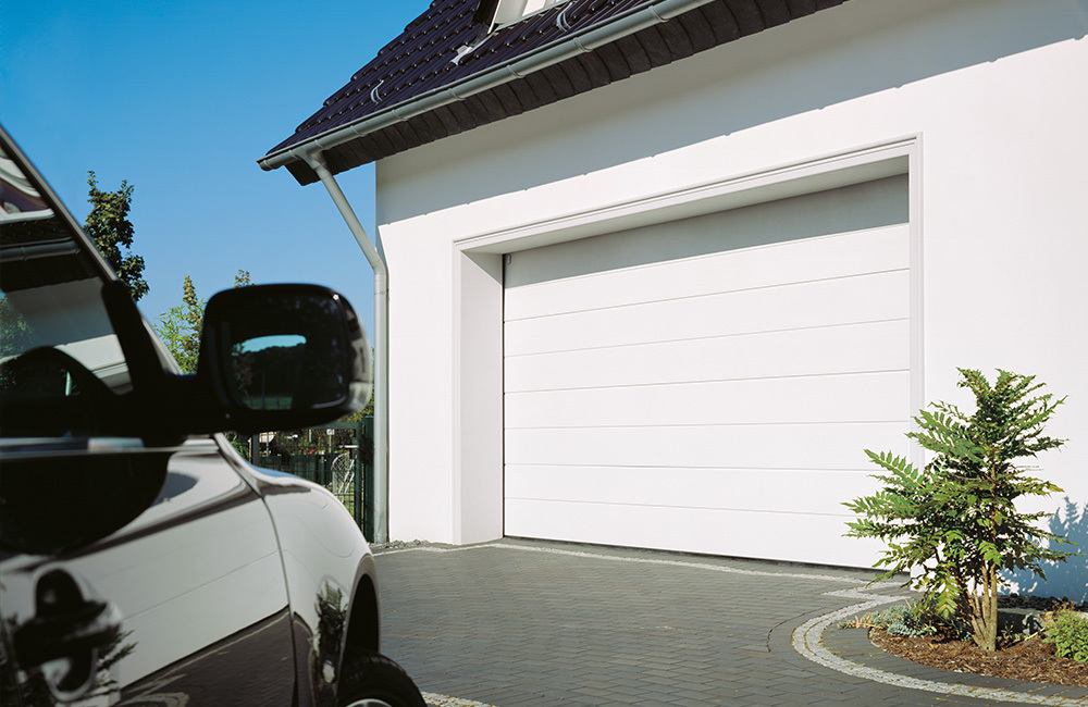 White residential automatic sectional garage door